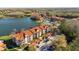 Aerial view showcasing the complex, situated near a lake, featuring a mix of green spaces and parking areas at 4209 Woodstorks Walk Way # 1304, Lutz, FL 33558
