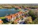 Aerial shot of the complex at 4209 Woodstorks Walk Way #1304 Lutz, FL 33558, nestled near a lake at 4209 Woodstorks Walk Way # 1304, Lutz, FL 33558