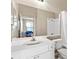 Well-lit bathroom with a large mirror, white vanity, and shower-tub combination at 4209 Woodstorks Walk Way # 1304, Lutz, FL 33558