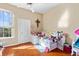 Bright bedroom features a large window, wood floors, and a ceiling fan at 4209 Woodstorks Walk Way # 1304, Lutz, FL 33558