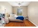 Cozy bedroom showcasing wood flooring, natural light, and a ceiling fan at 4209 Woodstorks Walk Way # 1304, Lutz, FL 33558