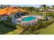 A beautiful community pool featuring plenty of lounge chairs and meticulously maintained landscaping at 4209 Woodstorks Walk Way # 1304, Lutz, FL 33558