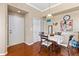 Cozy dining area with hardwood floors, a table set for four, and bright natural light at 4209 Woodstorks Walk Way # 1304, Lutz, FL 33558