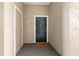 Condo unit entrance with a dark door, peephole, and 'Welcome Home' mat at 4209 Woodstorks Walk Way # 1304, Lutz, FL 33558