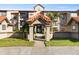 Beautiful condo building featuring manicured landscaping and attractive architectural details at 4209 Woodstorks Walk Way # 1304, Lutz, FL 33558