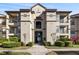 Condo building with multiple balconies, attractive landscaping, and common access stairs at 4209 Woodstorks Walk Way # 1304, Lutz, FL 33558