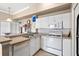 A bright kitchen with white cabinets, tile floors, and a microwave at 4209 Woodstorks Walk Way # 1304, Lutz, FL 33558