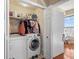 A well-equipped laundry room with modern washer, dryer, and storage shelves at 4209 Woodstorks Walk Way # 1304, Lutz, FL 33558