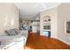 Open-concept living room with hardwood floors and a view of the kitchen and dining area at 4209 Woodstorks Walk Way # 1304, Lutz, FL 33558
