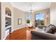 Comfortable living room featuring wood floors, ceiling fan, and slider to balcony at 4209 Woodstorks Walk Way # 1304, Lutz, FL 33558