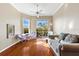 Inviting living room with hardwood floors, lots of natural light, and a ceiling fan at 4209 Woodstorks Walk Way # 1304, Lutz, FL 33558