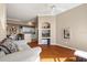 Cozy living room with a ceiling fan, wood floors, and access to the kitchen, with built-in shelving for storage and display at 4209 Woodstorks Walk Way # 1304, Lutz, FL 33558