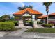 Community mail kiosk with a charming orange tile roof, surrounded by neatly manicured landscaping and greenery at 4209 Woodstorks Walk Way # 1304, Lutz, FL 33558