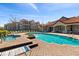 Community pool and hot tub near apartment buildings, featuring lounge chairs and well-maintained landscaping at 4209 Woodstorks Walk Way # 1304, Lutz, FL 33558