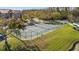 Aerial view of a fenced tennis court next to parking area in a well maintained community at 4209 Woodstorks Walk Way # 1304, Lutz, FL 33558
