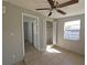 Bedroom featuring tile flooring, a ceiling fan, and a closet, with ample natural light at 4501 67Th N St, St Petersburg, FL 33709