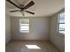 Bedroom with tile flooring, ceiling fan, neutral walls, and windows providing natural light at 4501 67Th N St, St Petersburg, FL 33709