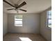 Bedroom with tile flooring, ceiling fan, neutral walls, and windows providing natural light at 4501 67Th N St, St Petersburg, FL 33709