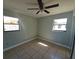 Bedroom featuring tile floors, a ceiling fan, and natural light from two windows at 4501 67Th N St, St Petersburg, FL 33709