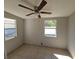 Bedroom with tile flooring, ceiling fan, neutral walls, and windows providing natural light at 4501 67Th N St, St Petersburg, FL 33709