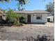 Charming single-story home featuring a red front door, white exterior, and small front yard at 4501 67Th N St, St Petersburg, FL 33709