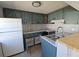 Kitchen with updated cabinets, neutral countertops, stainless steel sink, and modern fixtures at 4501 67Th N St, St Petersburg, FL 33709