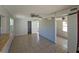 Open living room featuring tile floors, ceiling fan, ample natural light, and neutral walls at 4501 67Th N St, St Petersburg, FL 33709