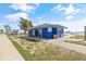 Exterior view of blue beach restrooms with trash cans on a sunny day at 4727 17Th S Ave, Gulfport, FL 33711