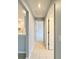 Bright hallway featuring tile floors leading to rooms with neutral paint scheme at 521 Tuscanny Park Loop, Brandon, FL 33511