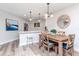 Dining area features a wood table set, decorative mirror, and a view to the modern kitchen at 6100 Bahia Del Mar Cir # 102, St Petersburg, FL 33715