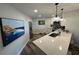 Modern kitchen featuring a quartz countertop island with bar stool seating and stainless steel appliances at 6100 Bahia Del Mar Cir # 102, St Petersburg, FL 33715