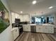 Bright kitchen features white cabinets, a quartz countertop island, and stainless steel appliances at 6100 Bahia Del Mar Cir # 102, St Petersburg, FL 33715
