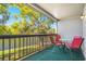 Relax on this cozy balcony overlooking a serene water view and lush trees at 6311 Newtown Cir # 11B2, Tampa, FL 33615