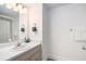 Bright bathroom featuring a vanity with sink, a mirror, and white tiles at 6311 Newtown Cir # 11B2, Tampa, FL 33615