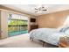 Bright bedroom with sliding doors to a screened balcony and neutral decor at 6311 Newtown Cir # 11B2, Tampa, FL 33615