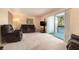Living room showcases cozy seating, balcony access, and neutral color palette at 6311 Newtown Cir # 11B2, Tampa, FL 33615