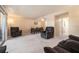 Spacious living room features neutral carpet, comfortable seating, and adjacent dining area at 6311 Newtown Cir # 11B2, Tampa, FL 33615