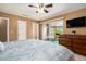 Spacious bedroom with a view of the balcony and a TV for entertainment at 6311 Newtown Cir # 11B2, Tampa, FL 33615