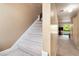 Carpeted staircase with neutral walls leading to the upper level of the home at 6311 Newtown Cir # 11B2, Tampa, FL 33615