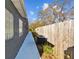 Exterior side yard showcasing the home's facade, windows, and fence at 6935 Dimarco Rd, Tampa, FL 33634