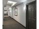 Well-lit condo hallway with neutral tones, carpeted floors, artwork, and access to multiple units at 700 S Harbour Island Blvd # 204, Tampa, FL 33602
