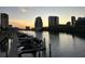 Tranquil waterfront scene featuring boat docks and the city skyline in the background during sunset at 700 S Harbour Island Blvd # 204, Tampa, FL 33602