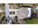 Overhead view of the home, including a screened-in porch and landscaped yard at 733 Seminole Blvd, Tarpon Springs, FL 34689