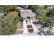 An aerial view of the home, featuring a spacious driveway and landscaping at 733 Seminole Blvd, Tarpon Springs, FL 34689