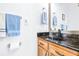 Modern bathroom features wood cabinets, black hardware and marble countertops at 733 Seminole Blvd, Tarpon Springs, FL 34689