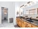 Bathroom with double vanity, granite countertop, and walk-in closet at 733 Seminole Blvd, Tarpon Springs, FL 34689