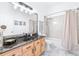 Bathroom featuring black granite counter top, tile floors, and shower at 733 Seminole Blvd, Tarpon Springs, FL 34689