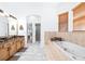 Bright bathroom featuring a tub and shower, double vanity, and marble floors at 733 Seminole Blvd, Tarpon Springs, FL 34689