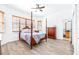 This spacious bedroom features natural light, a four-poster bed, and an ensuite bathroom at 733 Seminole Blvd, Tarpon Springs, FL 34689