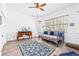 Well lit bedroom featuring a ceiling fan, wood floors, and bright airy lighting at 733 Seminole Blvd, Tarpon Springs, FL 34689